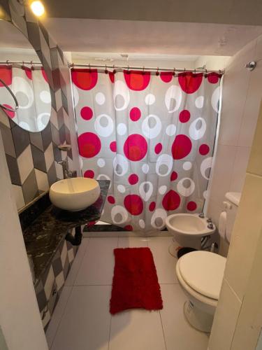 a bathroom with a toilet and a sink at Valentino in Termas de Río Hondo