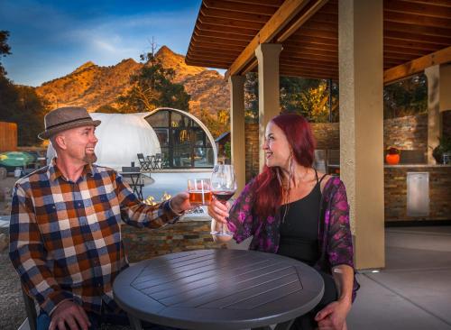a man and a woman holding a glass of beer at Sequoia Studio Suites in Three Rivers