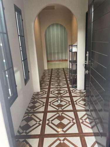 a hallway with a tile floor and a door at พฤกษากานต์3 in Kanchanaburi City
