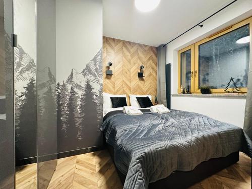 a bedroom with a bed and a window with mountains at Apartament Nad Strumykiem z SAUNĄ - 5D Apartamenty in Szklarska Poręba