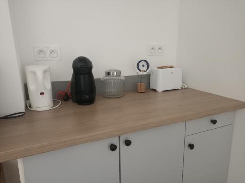 a counter top with a blender and other items on it at Le hangar de mamie in Prisse-la-Charriere