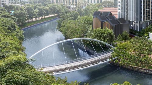 a bridge over a river in a city at Fraser Residence River Promenade, Singapore in Singapore