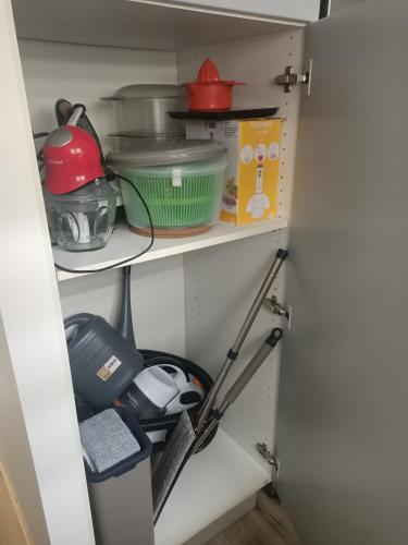 a pantry with dishes and other kitchen items at Le hangar de mamie in Prisse-la-Charriere