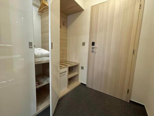 a walk in closet with white walls and a door at Hotel Podlesí in Podlesí