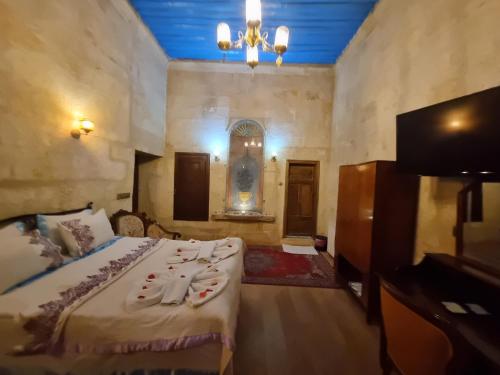 a bedroom with a bed and a chandelier at Born Hotel in Urgup