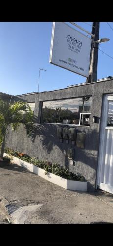 a building with a sign on the side of it at Vila da Drika in Rio das Ostras