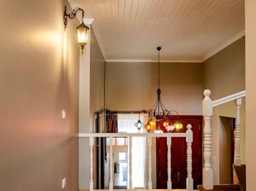 a chandelier is hanging in a room with a staircase at Private mansion in kumkapı in Istanbul