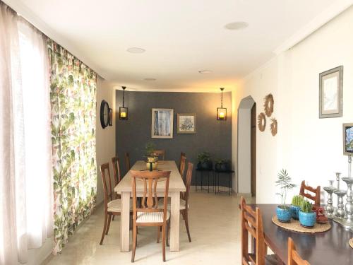 a dining room with a table and chairs at Guest House Vanda in Mestia