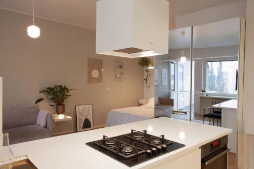 a kitchen and living room with a stove top oven at Luxury Nordic Loft with Great Kitchen and Location in Helsinki