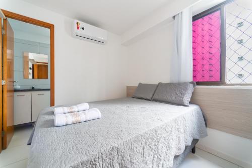 um quarto com uma cama com duas almofadas em Flat 701 - PortoMar Home Club no Recife