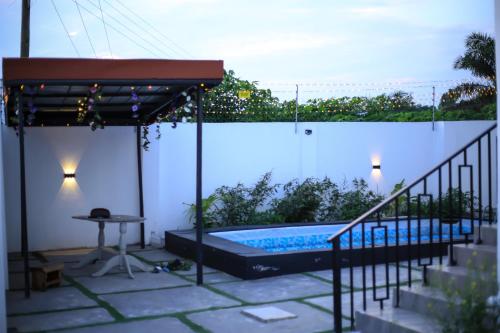 a patio with a swimming pool and a pergola at MILYREX VILLA 