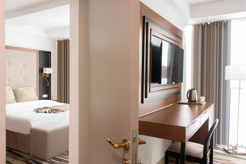 Ένα ή περισσότερα κρεβάτια σε δωμάτιο στο Shelter Inn Hotel & Spa