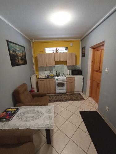 a living room with a table and a kitchen at Zacisze Sokolec in Ludwikowice Kłodzkie