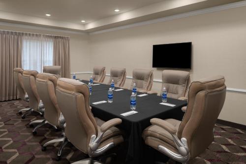 a conference room with a table and chairs and a television at Residence Inn East Rutherford Meadowlands in East Rutherford