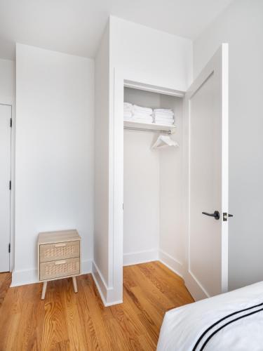 a bedroom with a closet and a bed and a wooden floor at Modern Three Bedroom Brooklyn Condo-Hotel in Brooklyn