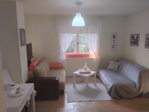 a living room with a couch and a table at Dečiji vinogradi Belgrade, Sopot, Kosmaj in Sopot