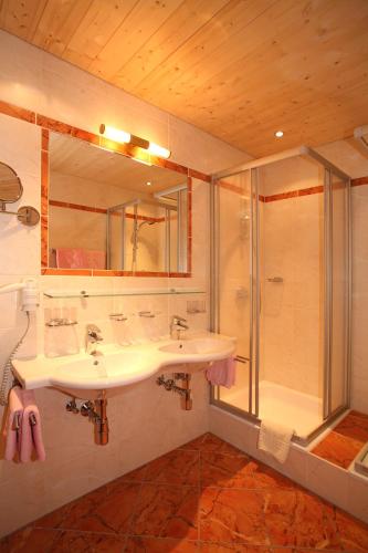 a bathroom with a sink and a shower at Hotel Silbertal - Almhütten in Sölden