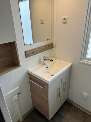a bathroom with a sink and a mirror at MH TIKE - 4p - Les Sables du Midi - Valras in Valras-Plage