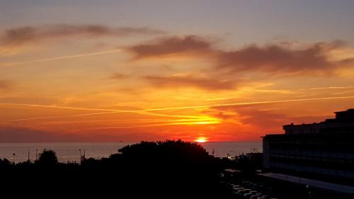a sunset over the ocean with at Attico Vista Mare in Tirrenia