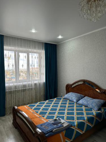 - une chambre avec un lit et une couette bleue dans l'établissement 1 ком квартира, à Aket