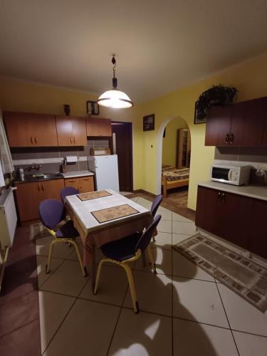 a kitchen with a table and chairs in a room at Zacisze Sokolec in Ludwikowice Kłodzkie