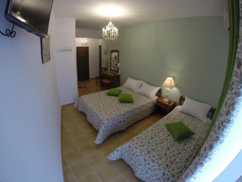 a room with two beds and a chandelier at Akrotiri Hotel in Neos Marmaras