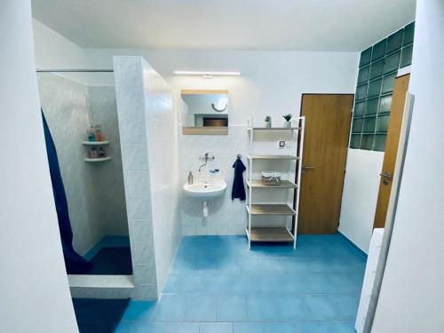 a small bathroom with a sink and a toilet at Apartmán Mája in Rumburk