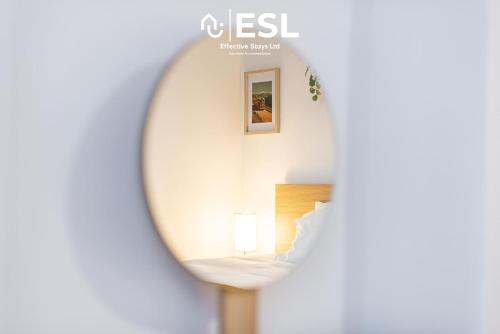a mirror reflection of a bed in a room at 3 bedroom House - Next to Wrexham FC Racecourse Stadium in Wrexham