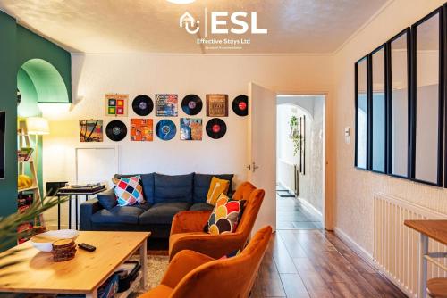 a living room with a couch and a table at 3 bedroom House - Next to Wrexham FC Racecourse Stadium in Wrexham