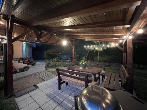 a wooden patio with a bench and a table at Útulný malý domček s vírivkou in Košice