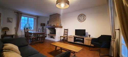un salon avec un canapé et une cheminée dans l'établissement Le Croisic Brocéliande, au Croisic