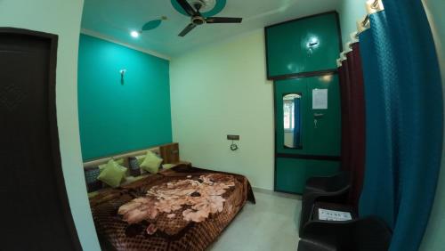 a bedroom with a bed and a ceiling fan at Rudransh home stay in Rishīkesh