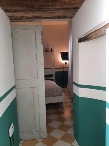 a room with a door and a bedroom with a bed at Le Case di LuVi in Nola