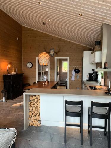 een keuken met een bar met 2 stoelen en een tafel bij Granfjällsporten 57 in Stöten