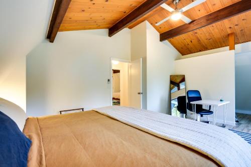 a bedroom with a large bed and a table at Modern Oregon Getaway with Fireplace, Yard and Deck in Boring