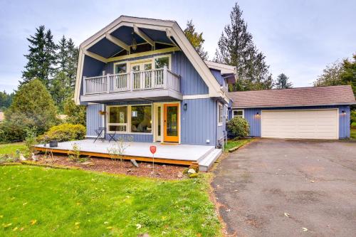 a blue house with a porch and a garage at Modern Oregon Getaway with Fireplace, Yard and Deck in Boring