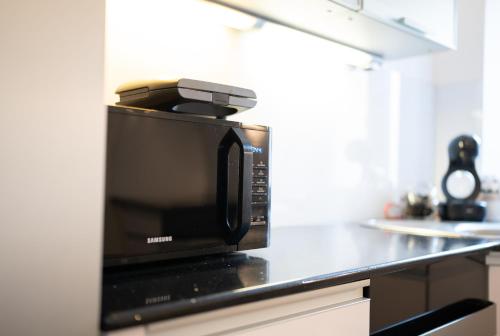 a microwave sitting on top of a kitchen counter at Celje Center Apartment in Celje