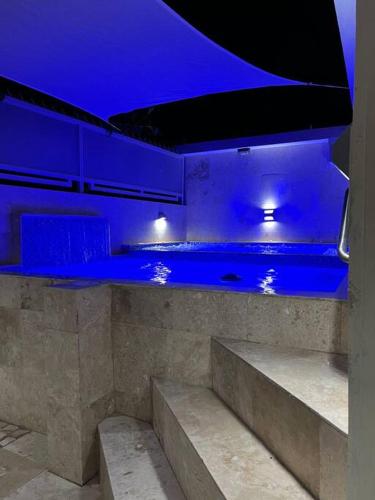 a kitchen with blue lighting and stairs in a room at Palmas View Premium 7 in Humacao