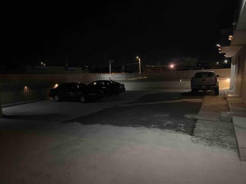 two cars parked in a parking lot at night at Palmas View Premium 7 in Humacao