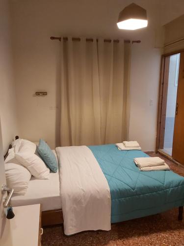 a bedroom with two beds and a window at Ermis Hotel 