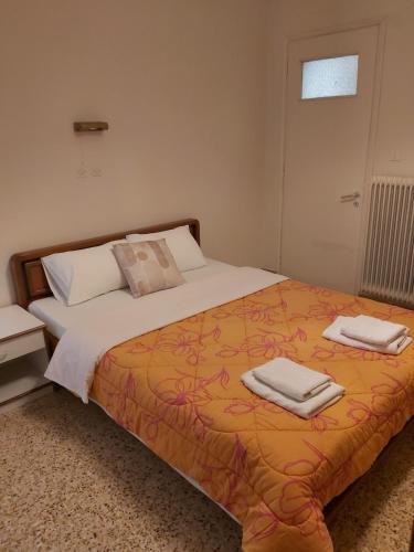 a bedroom with a bed with two towels on it at Ermis Hotel 