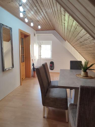 a dining room with a table and chairs and a staircase at Be Home! 2. Apartment Gratkorn in Gratkorn
