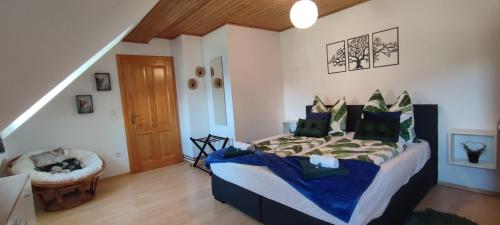 a bedroom with a bed with a blue comforter at Be Home! 2. Apartment Gratkorn in Gratkorn