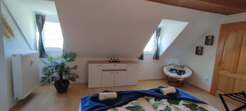 a bedroom with a bed with a blue blanket on it at Be Home! 2. Apartment Gratkorn in Gratkorn