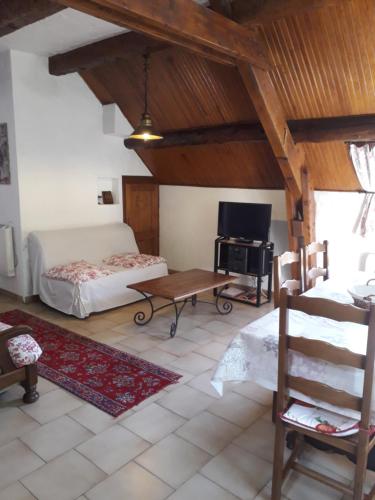 un salon avec un lit, un bureau et une télévision dans l'établissement Appart chalet, à Saint-Martin-Vésubie