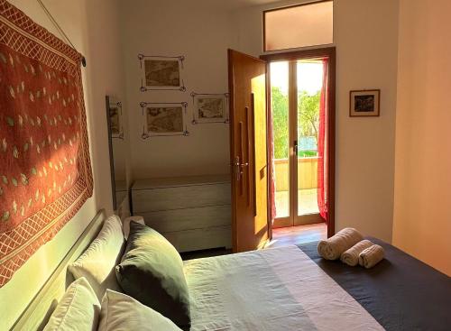 a bedroom with a bed with two towels on it at Lo Zio Michele Apartments in Nuova Gibellina