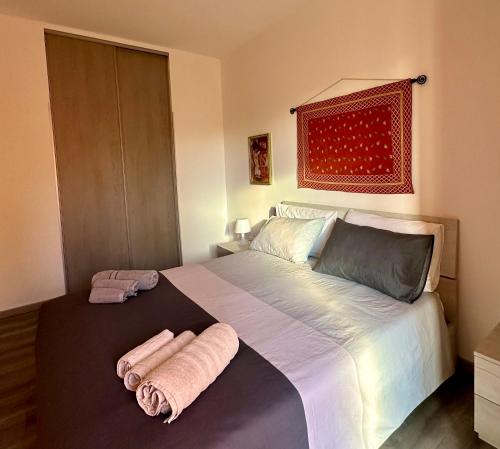 a bedroom with a large bed with towels on it at Lo Zio Michele Apartments in Nuova Gibellina