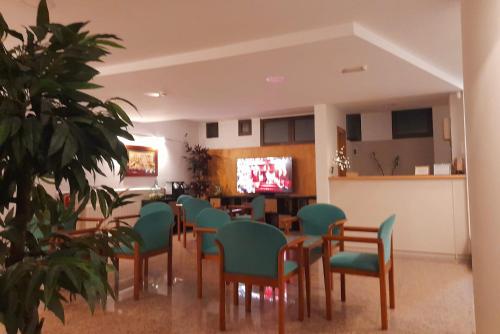 comedor con sillas, mesa y TV en Hotel Villa De Lerma, en Lerma