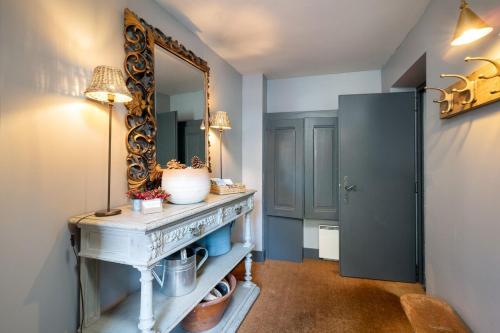 a room with a mirror and a dressing table at La Ruinette - Boutique Apartments in Le Châble
