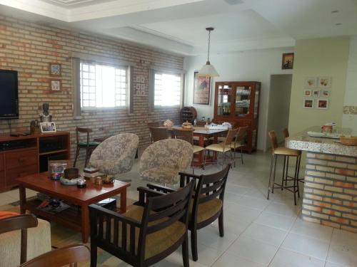 a living room with a table and chairs at Casa na Faz Real in Teresina